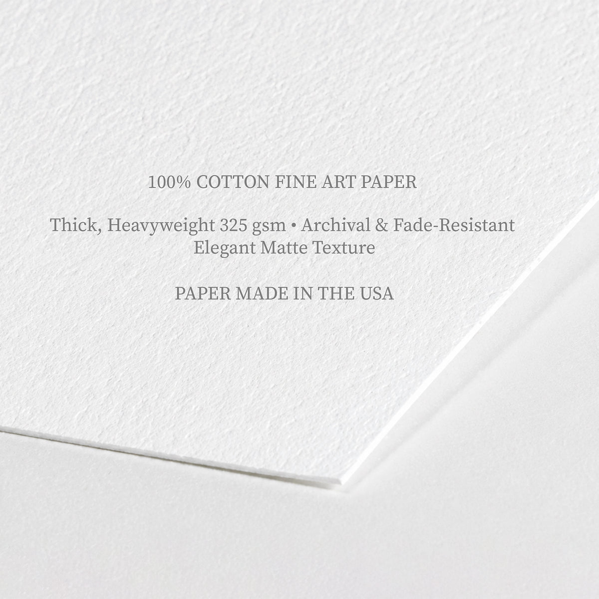 Close-up angle of thick 325 gsm 100% cotton fine art paper detailing archival quality, fade resistance, and matte texture for nursery prints.