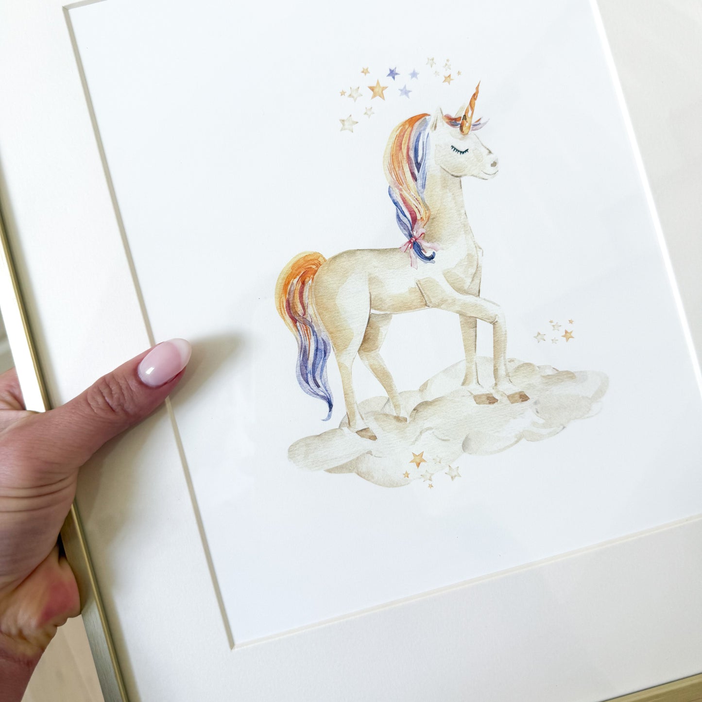 Watercolor unicorn with rainbow tail and mane with a cloud and stars