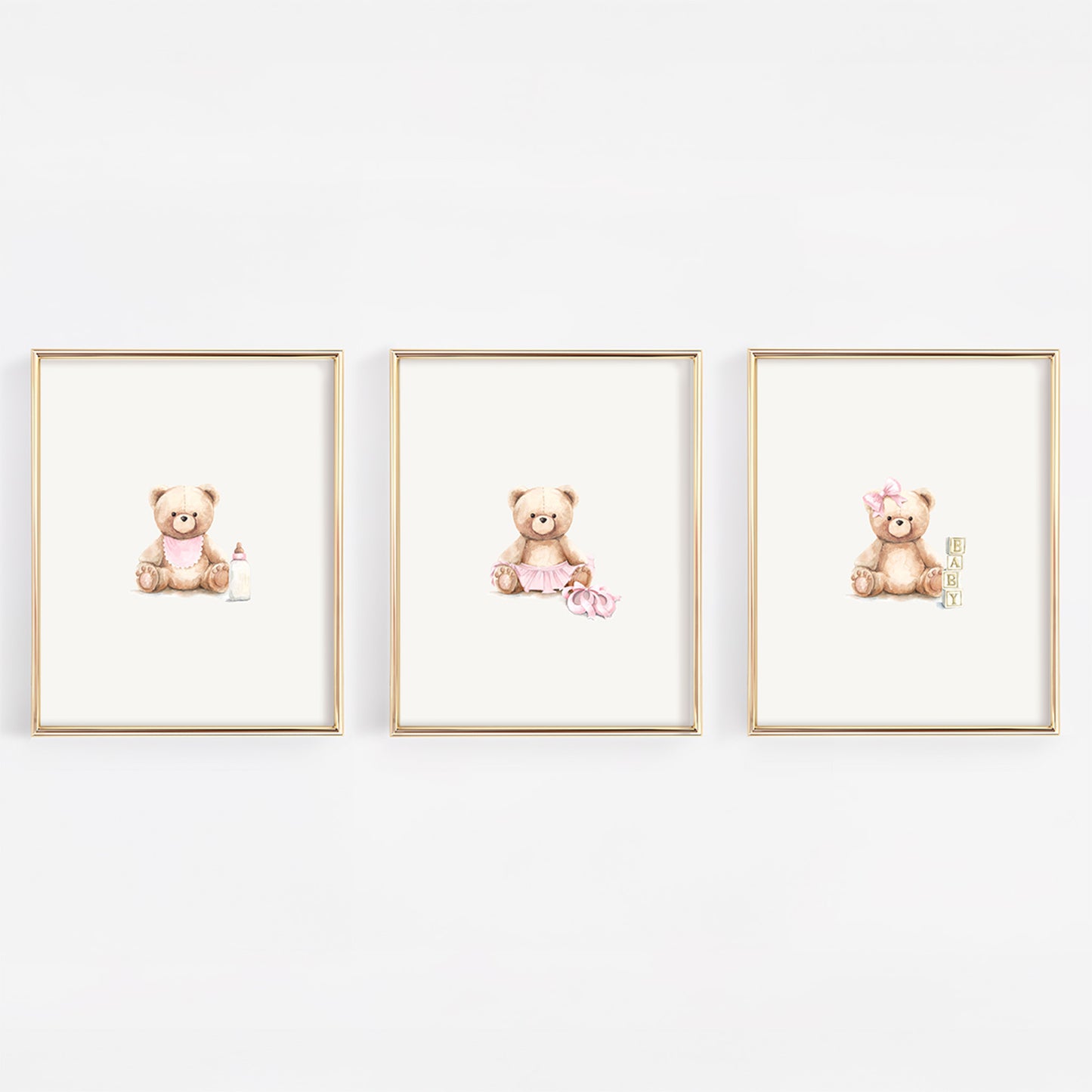 Three framed prints of teddy bears on a white wall
