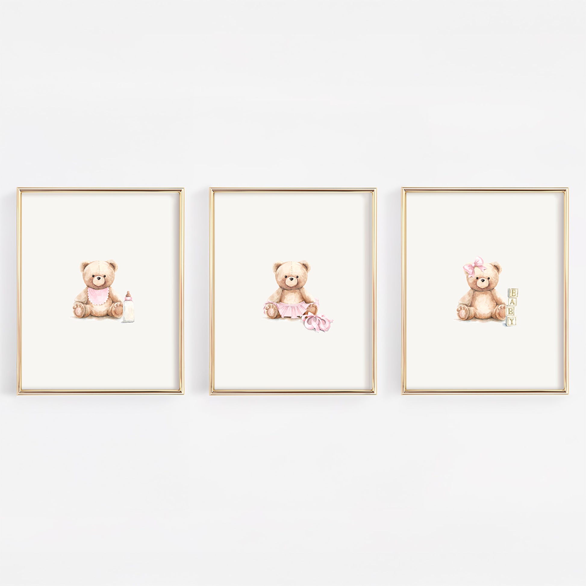 Three framed prints of teddy bears on a white wall