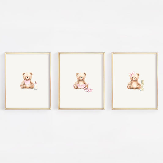 Three framed prints of teddy bears on a white wall