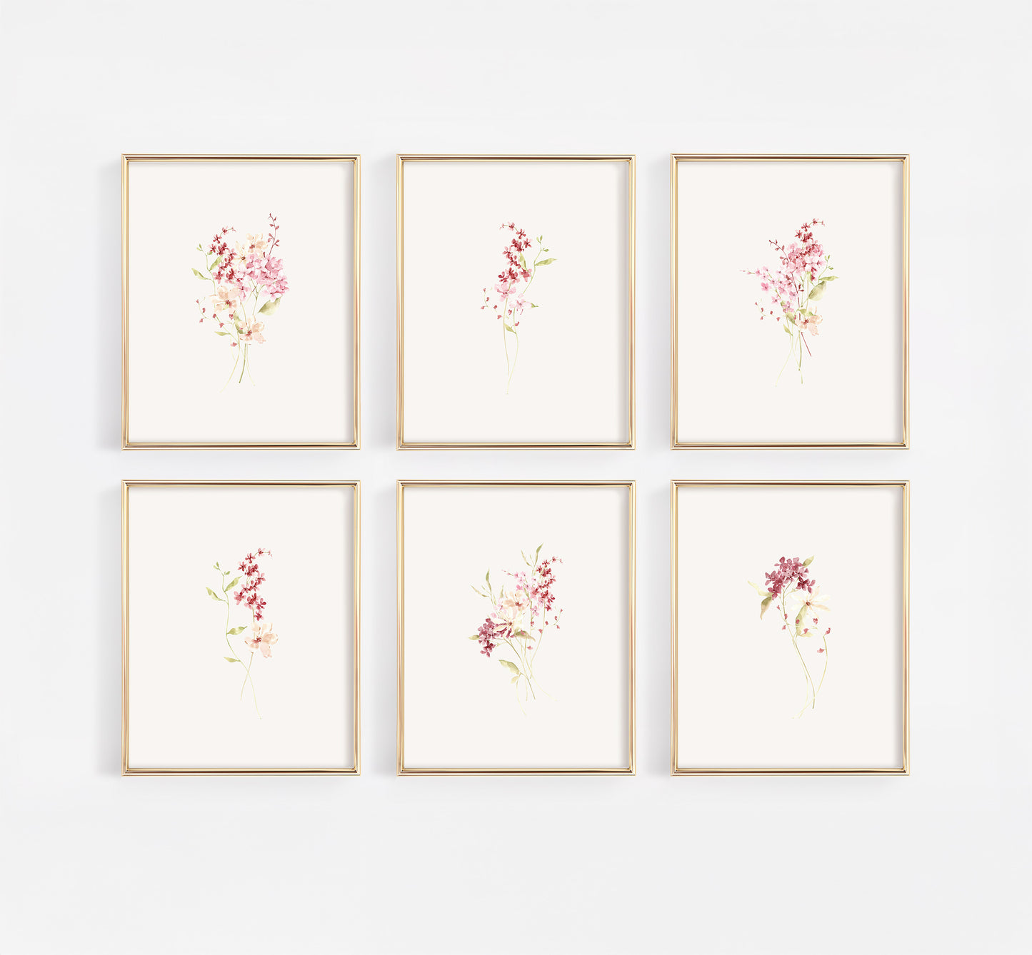 Comprehensive gallery wall set of six gold-framed nursery prints featuring a curated collection of dusty rose and burgundy wildflowers in a modern watercolor style.
