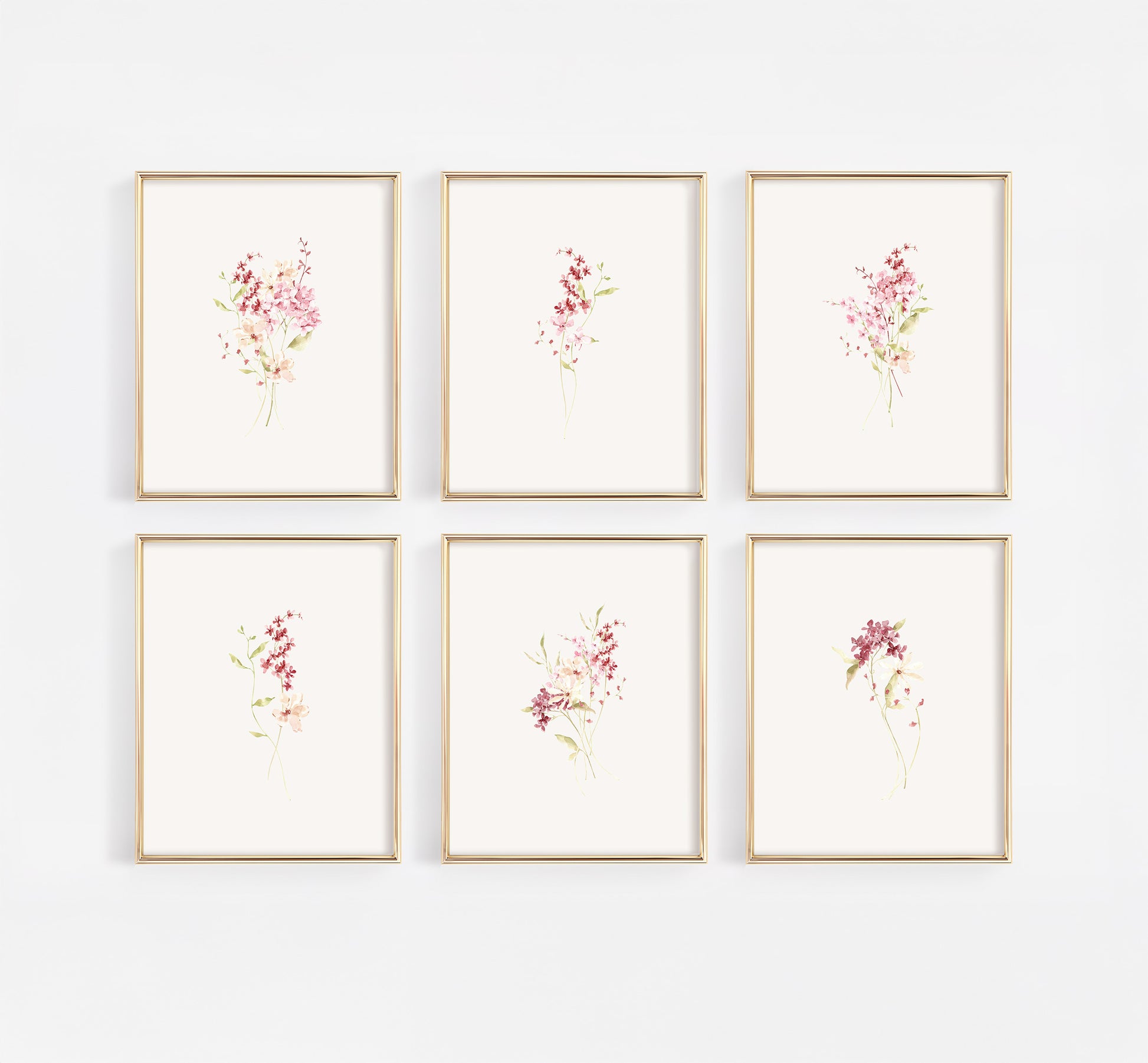 Comprehensive gallery wall set of six gold-framed nursery prints featuring a curated collection of dusty rose and burgundy wildflowers in a modern watercolor style.