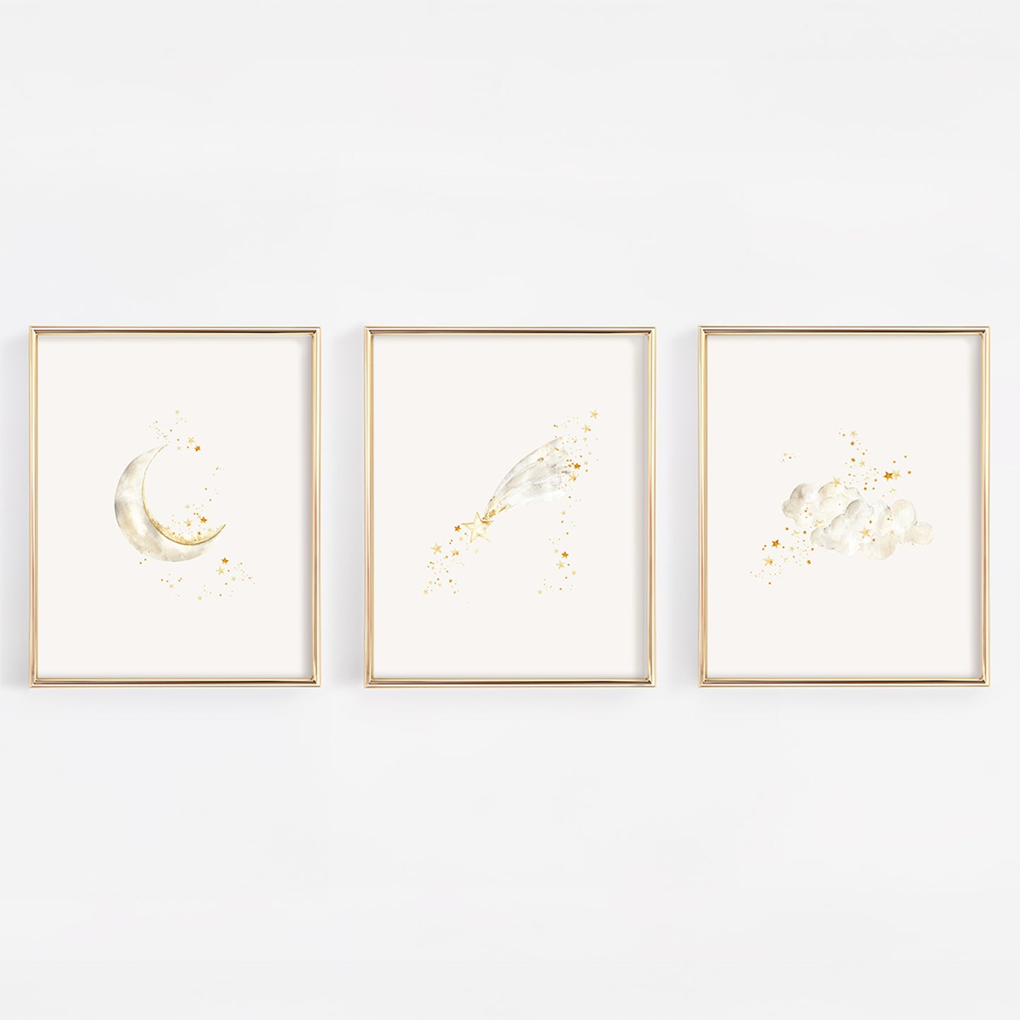 Set of three celestial nursery art prints in gold frames featuring a crescent moon with stars, a whimsical shooting star, and soft clouds with twinkling stars.