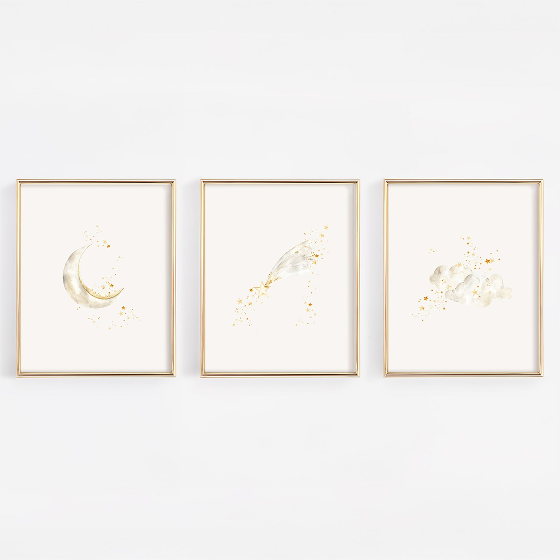 Set of three celestial nursery art prints in gold frames featuring a crescent moon with stars, a whimsical shooting star, and soft clouds with twinkling stars.