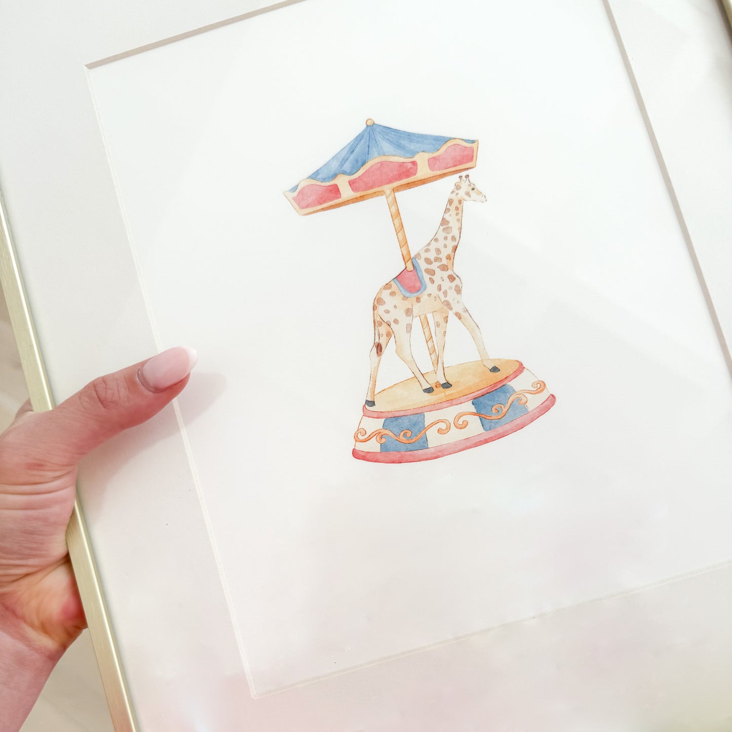 Watercolor painting of a giraffe on a carousel that’s red and blue vintage style.