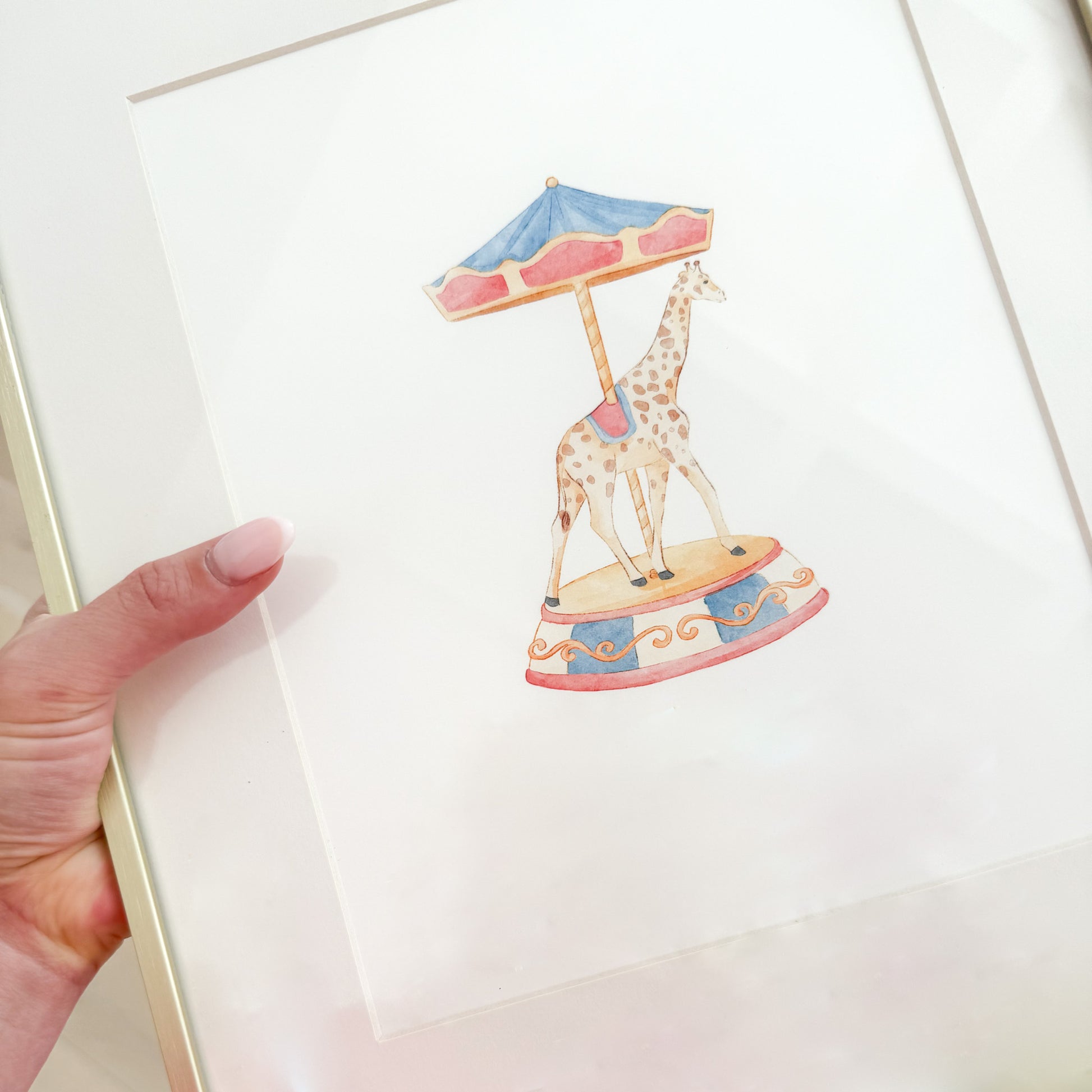 Watercolor painting of a giraffe on a carousel that’s red and blue vintage style.