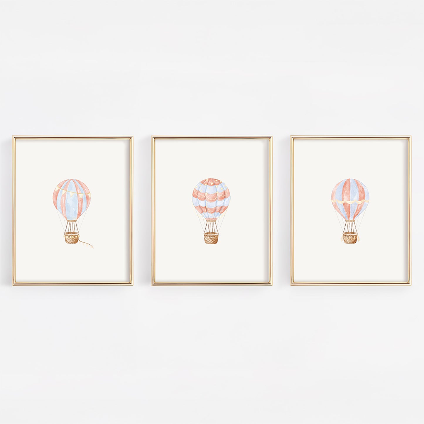 Three framed illustrations of hot air balloons on a white background