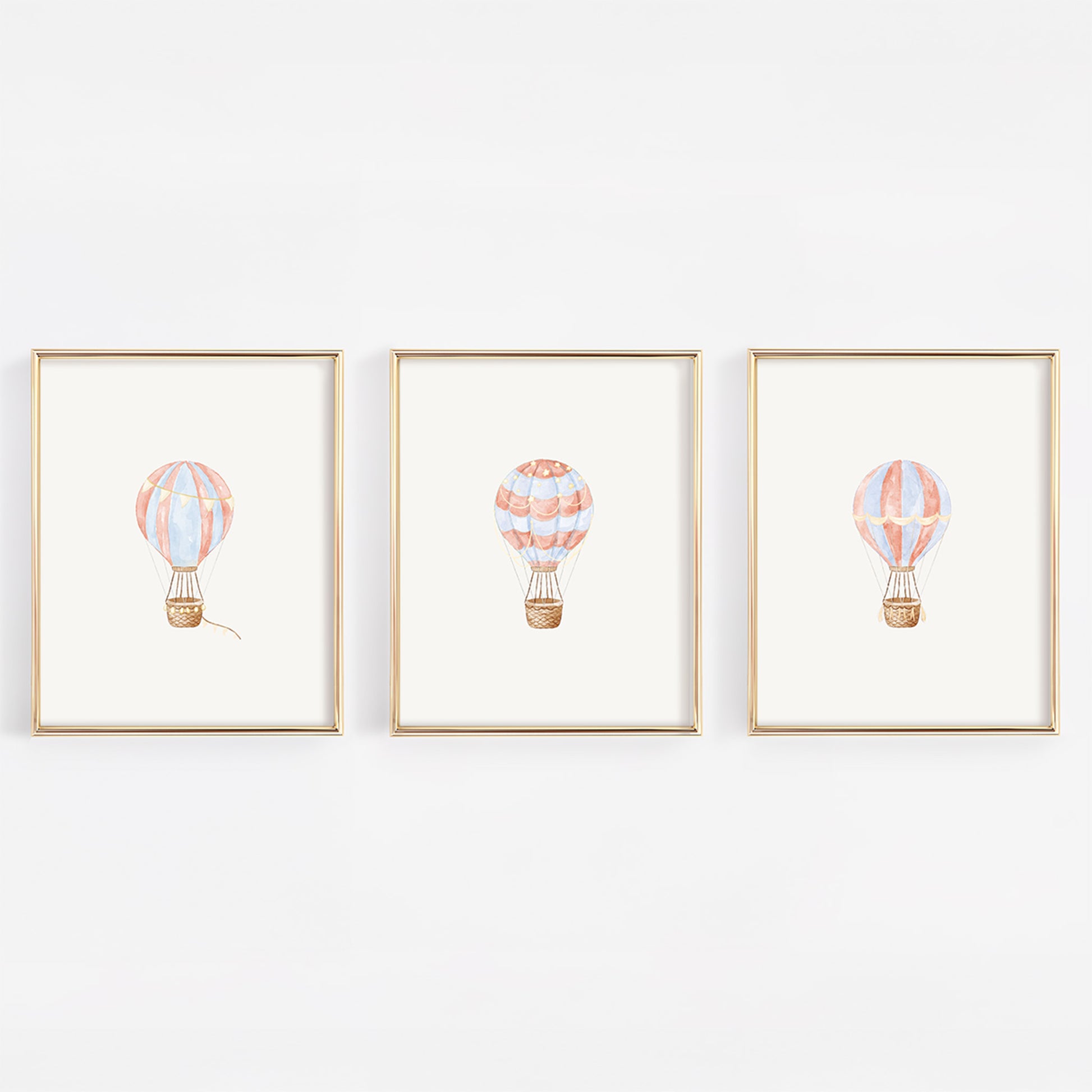Three framed illustrations of hot air balloons on a white background