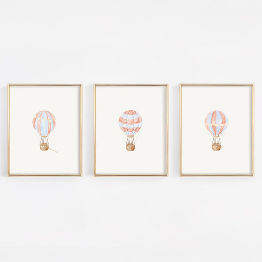 Three framed illustrations of hot air balloons on a white background