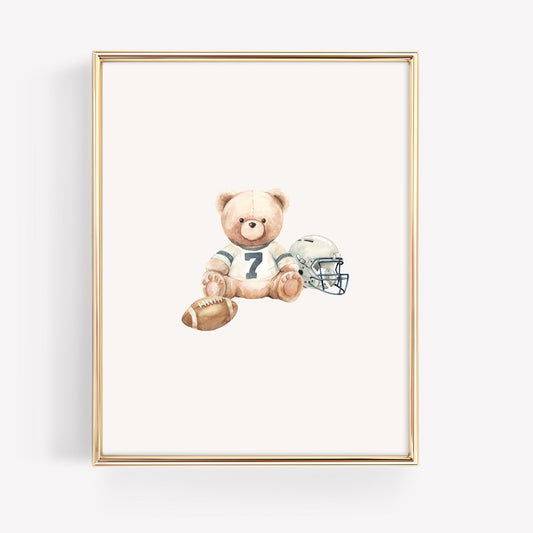 Framed artwork of a teddy bear holding a football and helmet on a white background