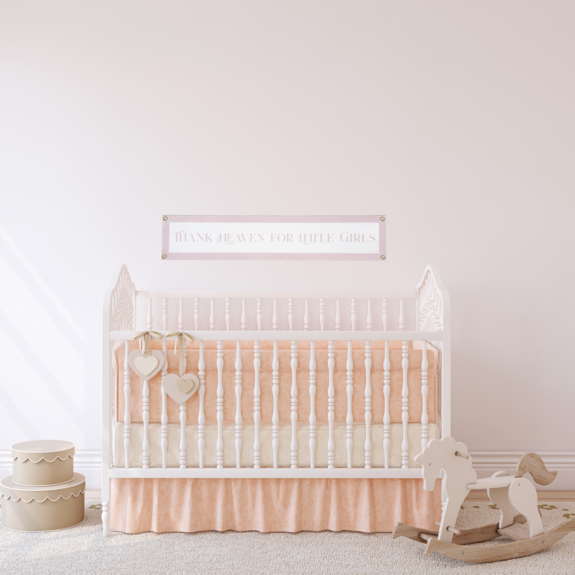 Pink and White decorative banner above nursery crib