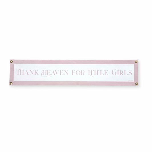 Decorative nursery banner with text 'Thank heaven for little girls' on a white background