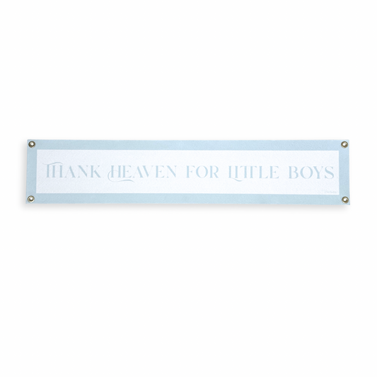 Blue baby boy nursery banner with 'Thank heaven for little boys' text on a white background