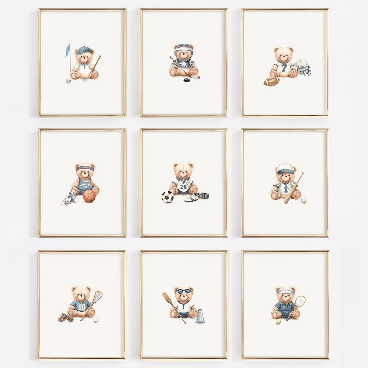 A 3x3 grid of nine framed watercolor prints featuring teddy bears playing sports, displayed on a light gray wall. Each print has a light wood frame and shows a different sport such as soccer, lacrosse, tennis, baseball, football, hockey, basketball, golf, crew, tennis.