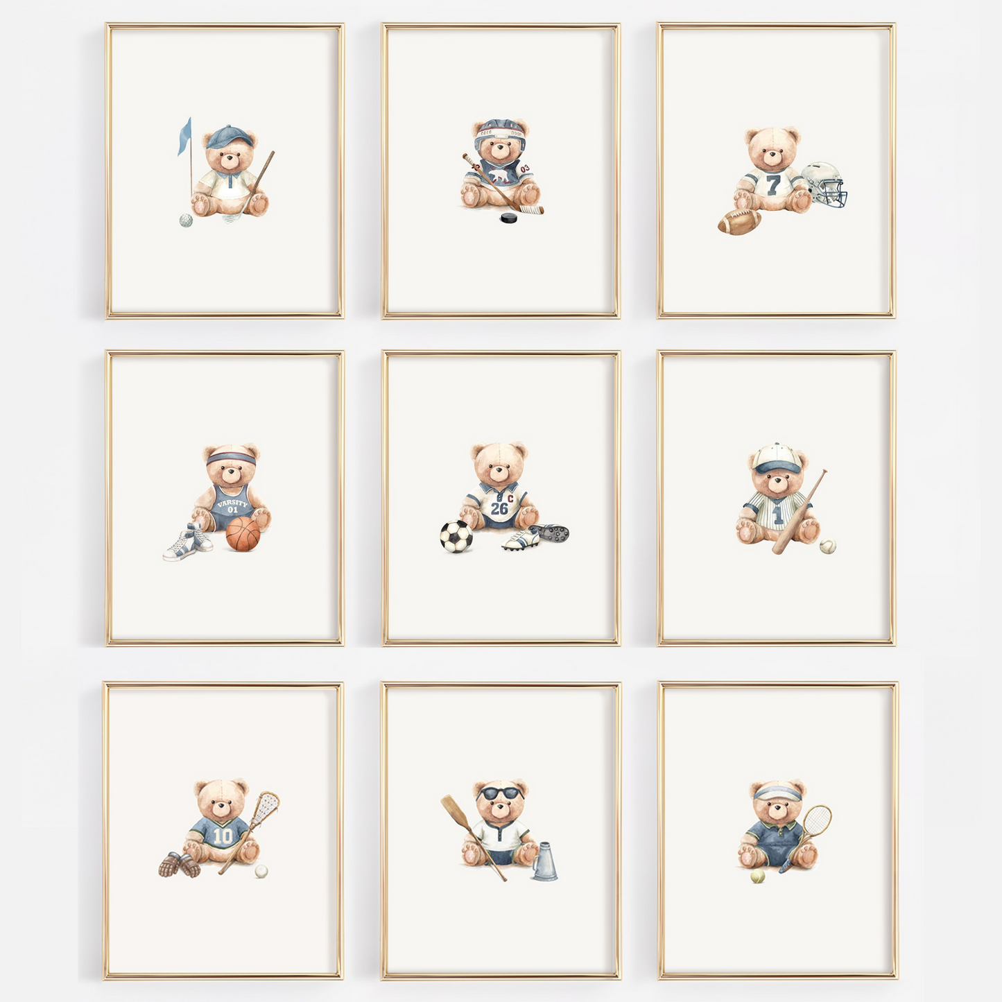 A 3x3 grid of nine framed watercolor prints featuring teddy bears playing sports, displayed on a light gray wall. Each print has a light wood frame and shows a different sport such as soccer, lacrosse, tennis, baseball, football, hockey, basketball, golf, crew, tennis.