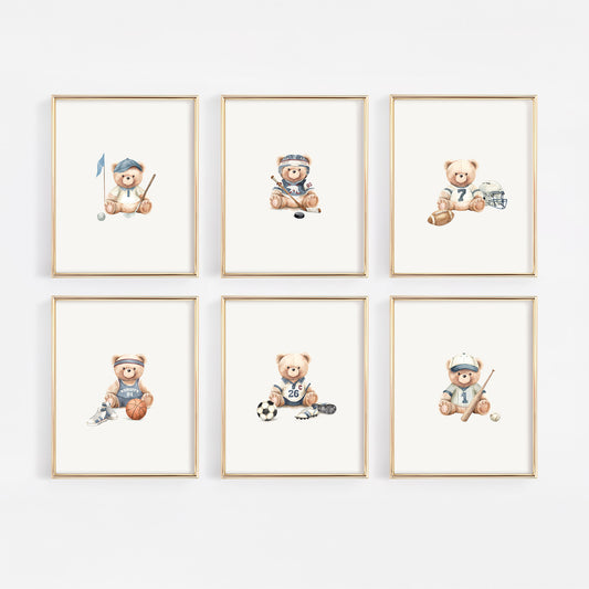 Six framed watercolor prints of teddy bears playing sports, arranged in a 2x3 grid on a light gray wall. Each bear wears a different sporty outfit and holds equipment like a golf club, hockey stick, soccer ball, and hockey puck.