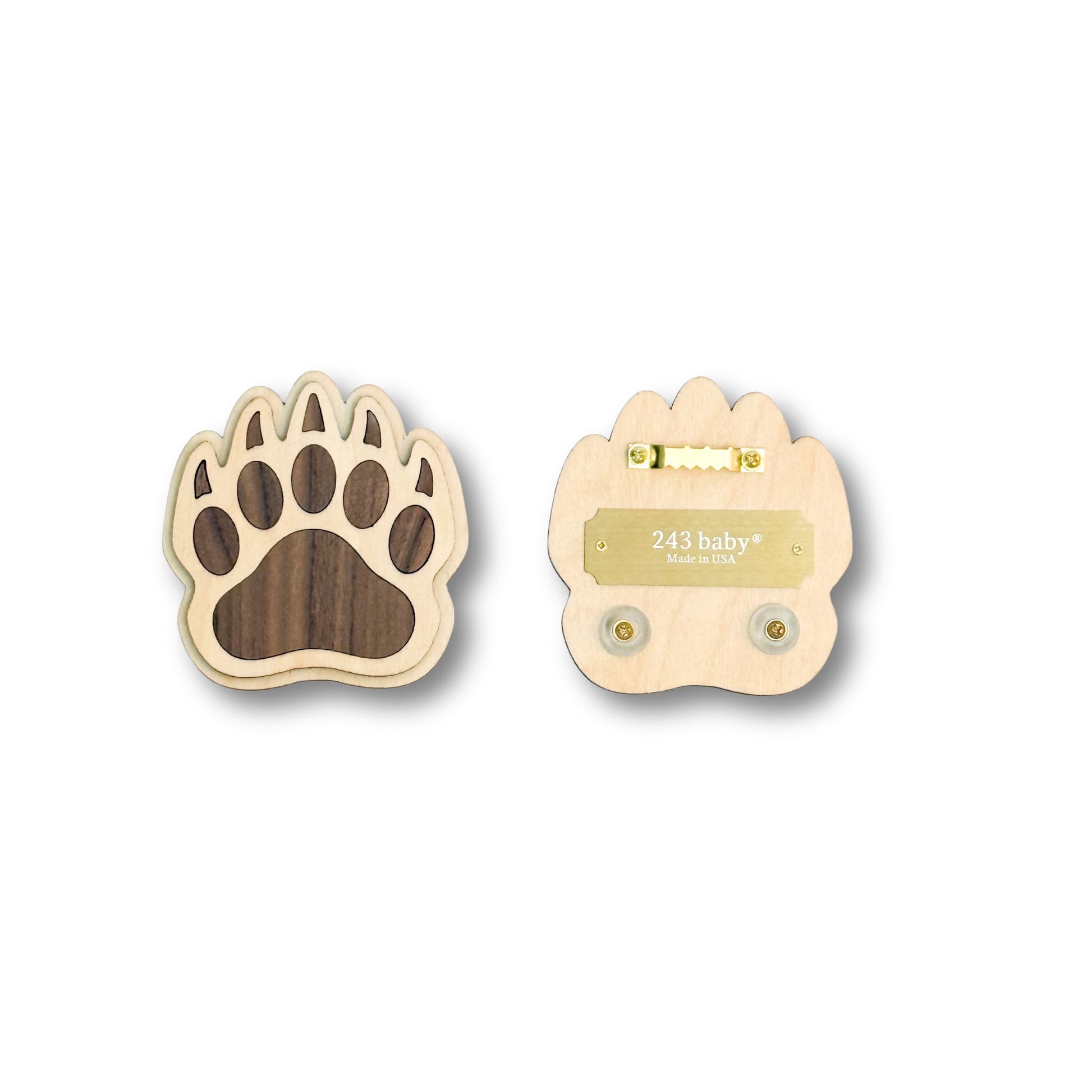 Two wooden paw prints with one having a brass logo and brass hangning on a white background