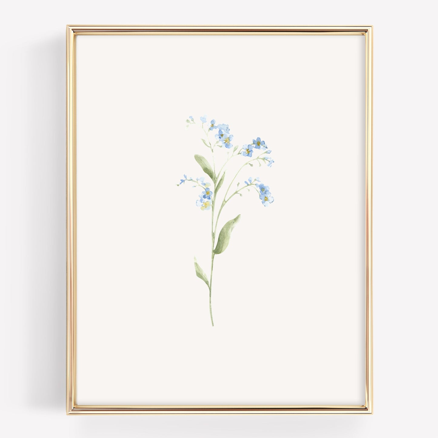 A vertical framed botanical art print featuring a delicate watercolor illustration of forget-me-nots in light blue and green on an off-white background, enclosed in a thin gold frame.