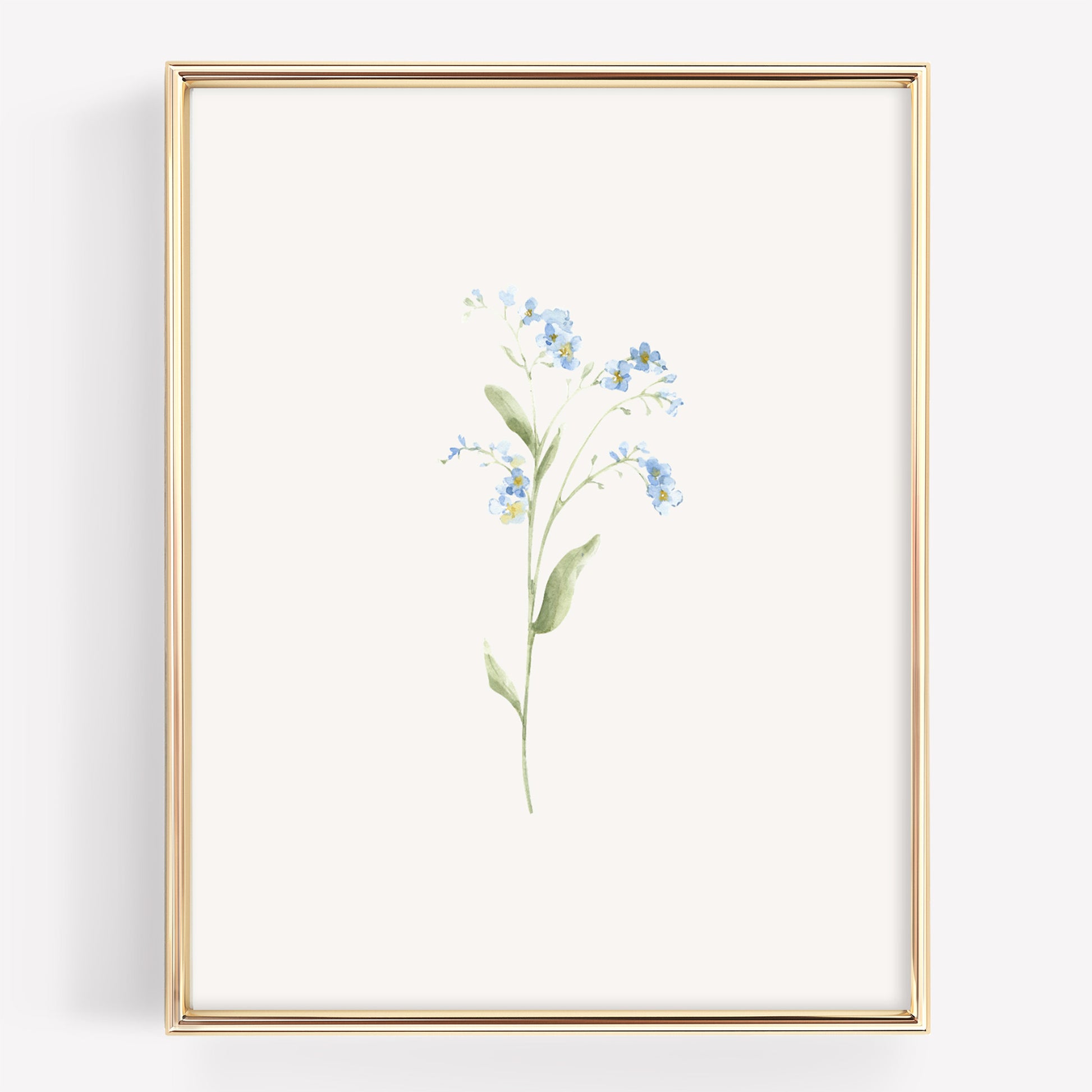 A vertical framed botanical art print featuring a delicate watercolor illustration of forget-me-nots in light blue and green on an off-white background, enclosed in a thin gold frame.