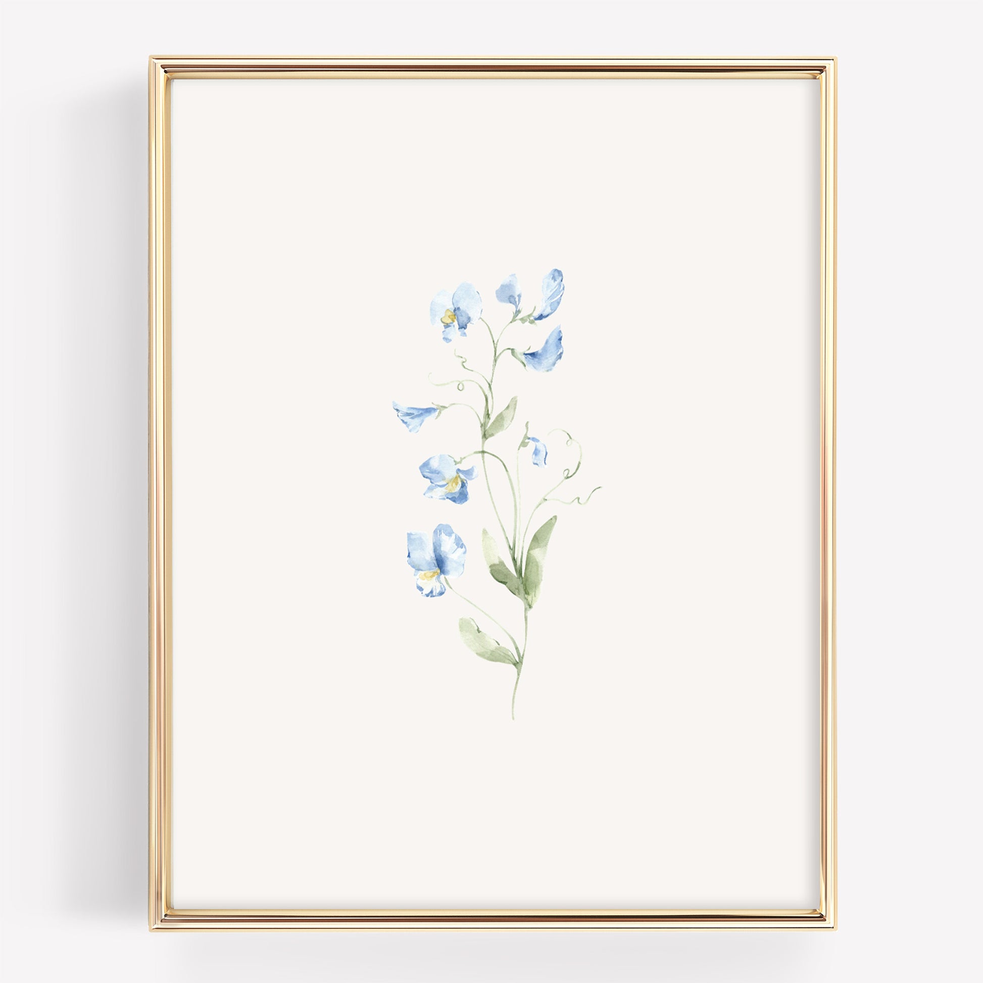 A vertical framed art print featuring a delicate watercolor illustration of light blue sweet pea flowers with green stems on an off-white background, enclosed in a thin gold frame.
