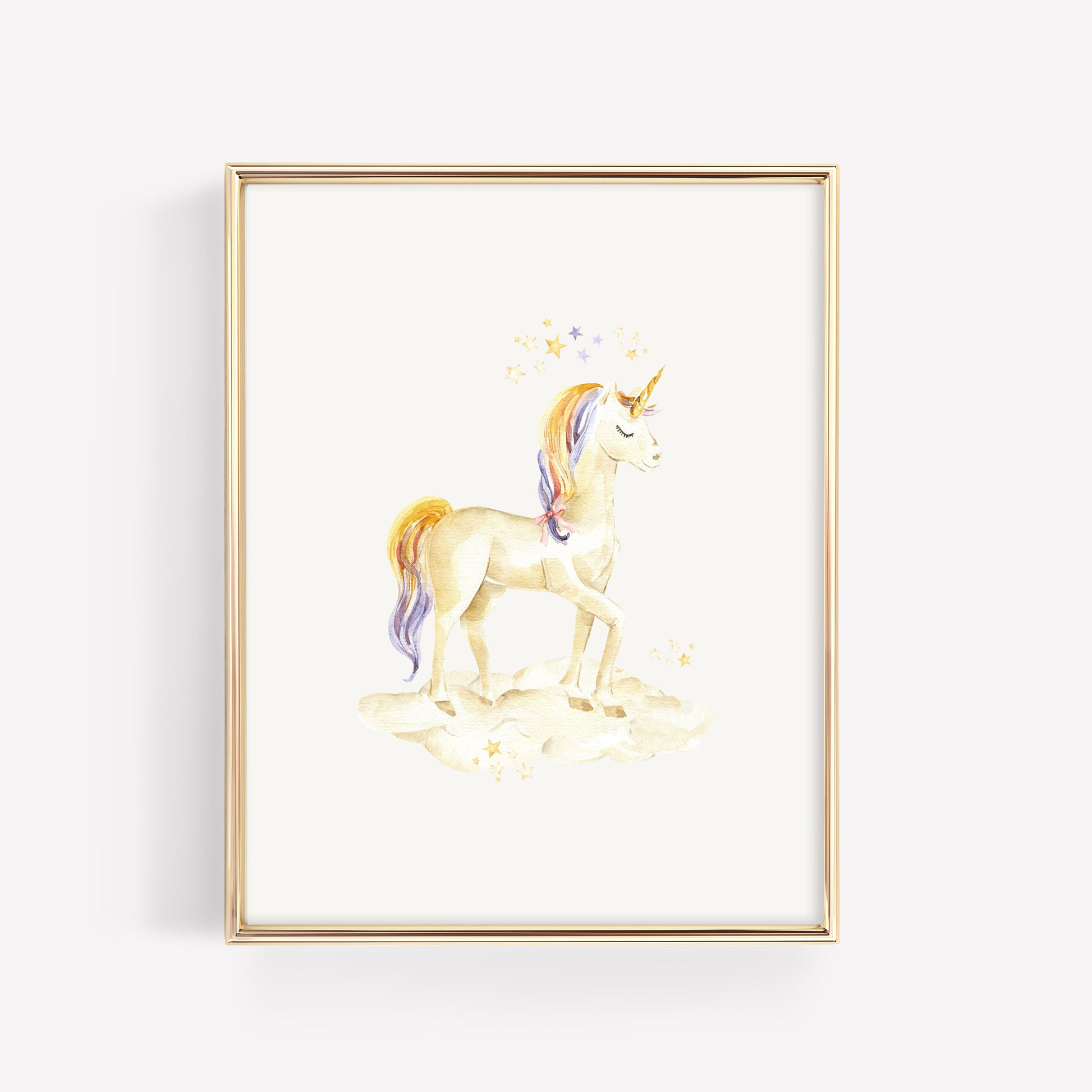 A framed watercolor art print of a unicorn standing on clouds, with a gold frame, shown against a light gray background.