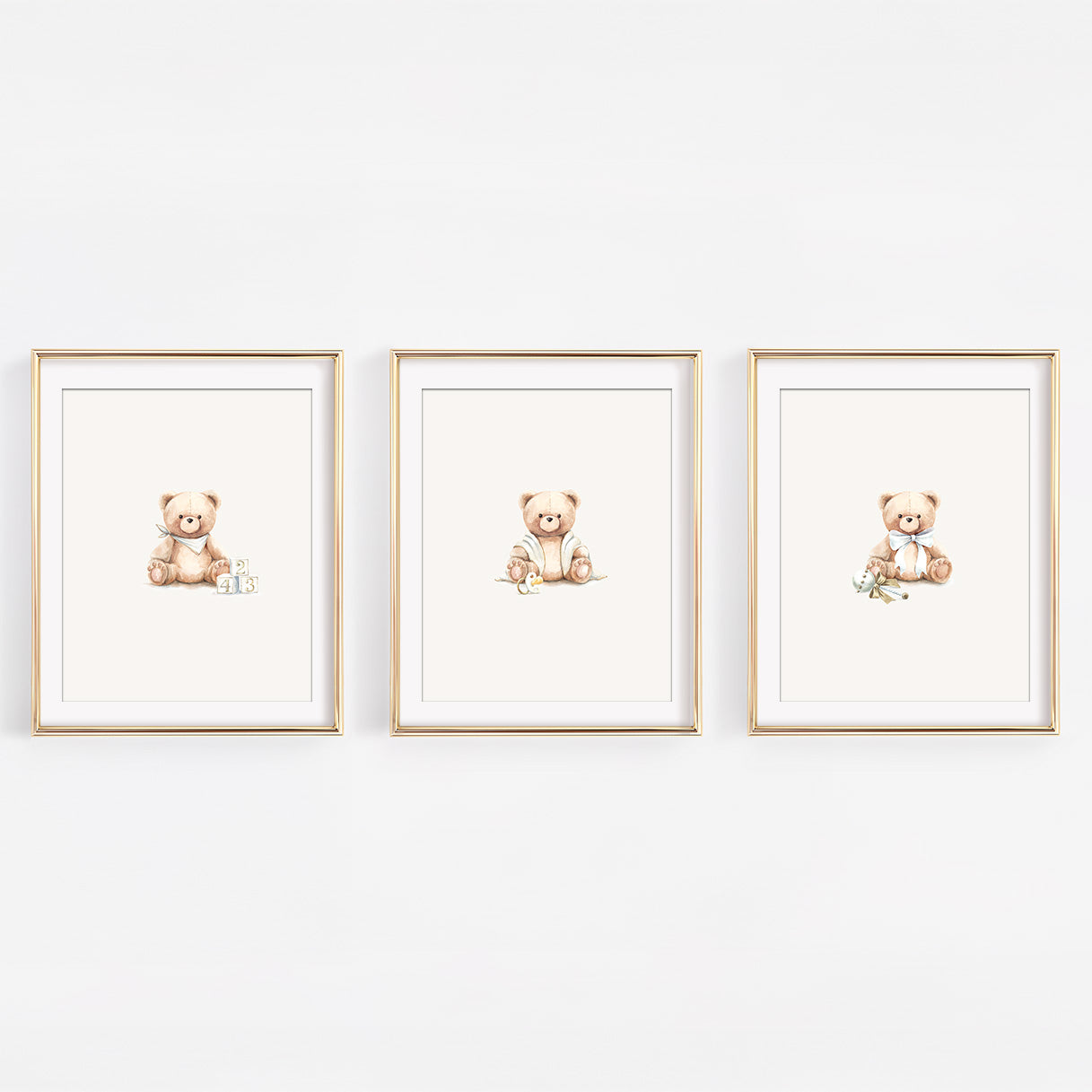 Set of three watercolor frost grey teddy bear nursery prints featuring bears with baby blocks, a rattle, and a binky. Elegant blue and silver decor for a baby boy.