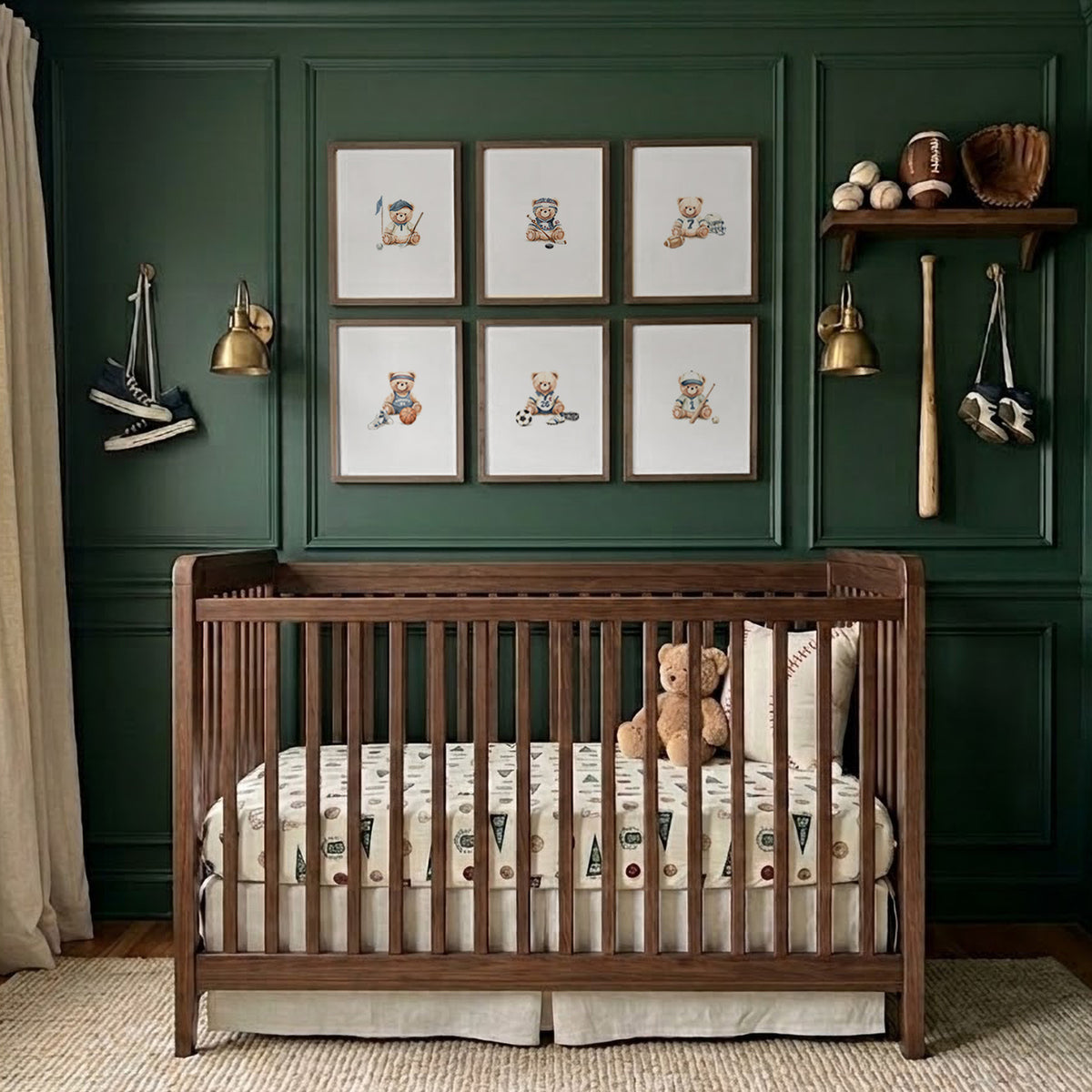 Set of 6 framed sports teddy bear watercolor art prints hanging on a dark green paneled nursery wall above a dark wooden crib.