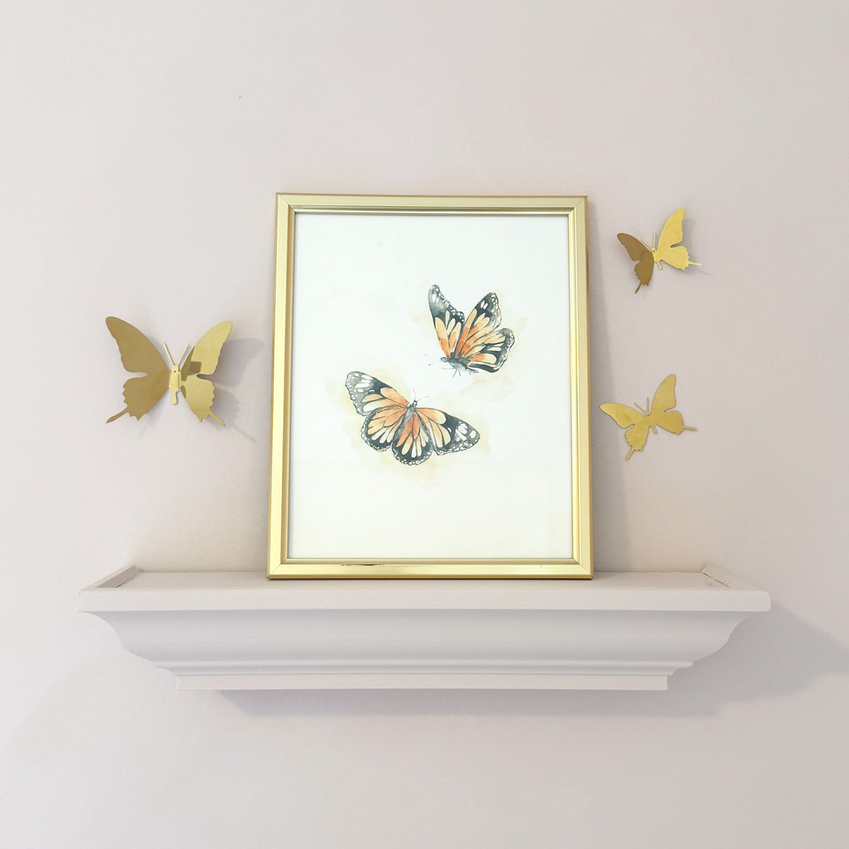 watercolor monarch butterflies for a girls nursery with 3D gold butterfly’s against a pink wall.