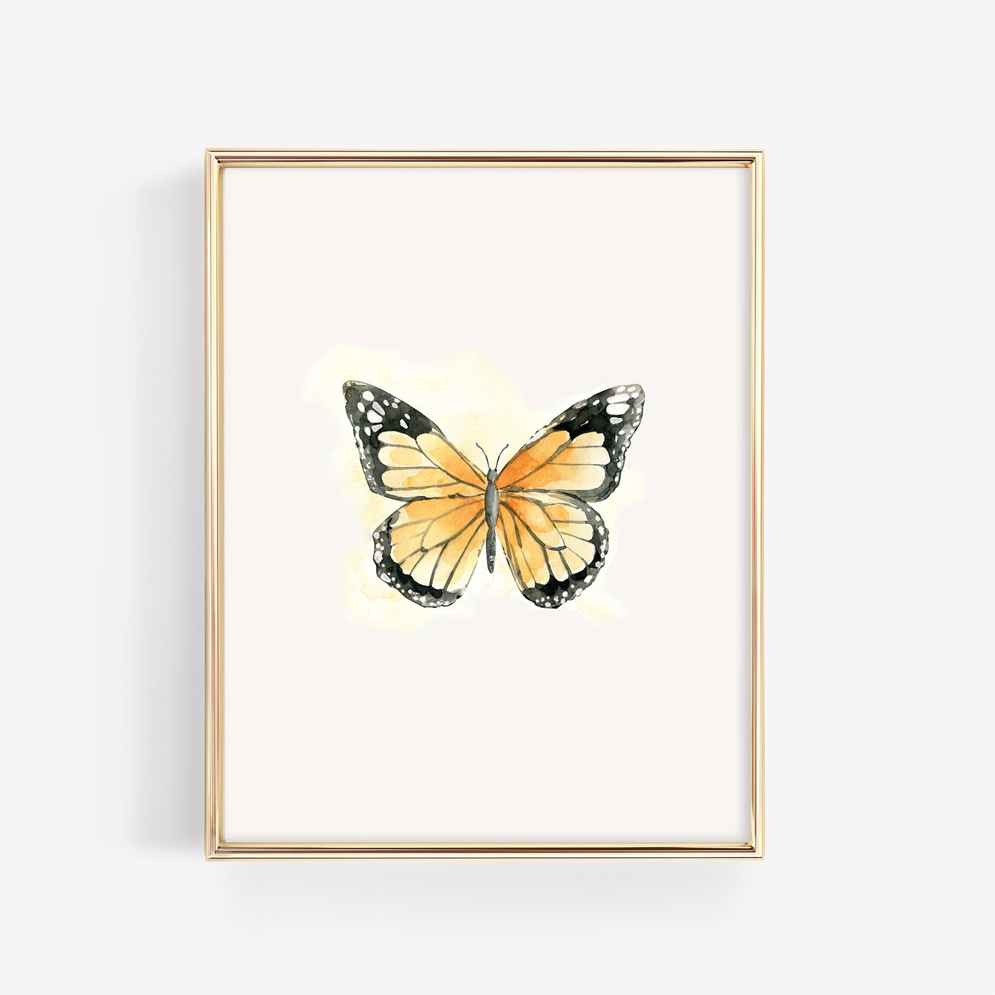 A single monarch butterfly with open wings and a faint orange artistic glow, displayed in a minimalist 8x10 gold frame for a garden-themed nursery.