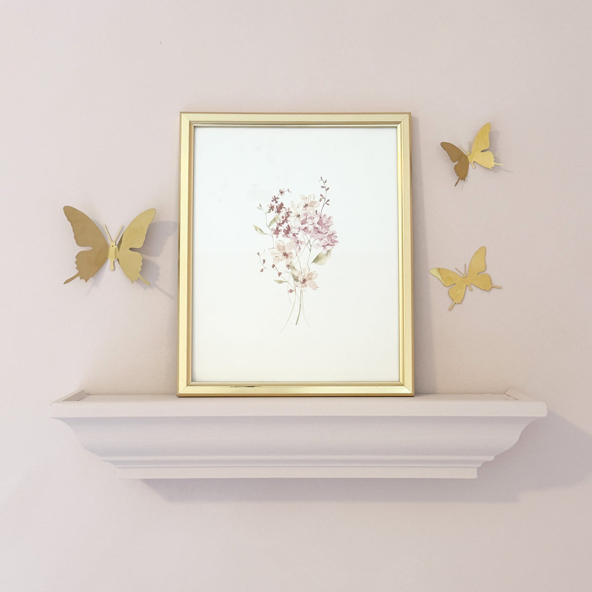 Pink and burgundy watercolor wildflowers for a girls nursery with gold 3D butterfly’s on the pink wall.