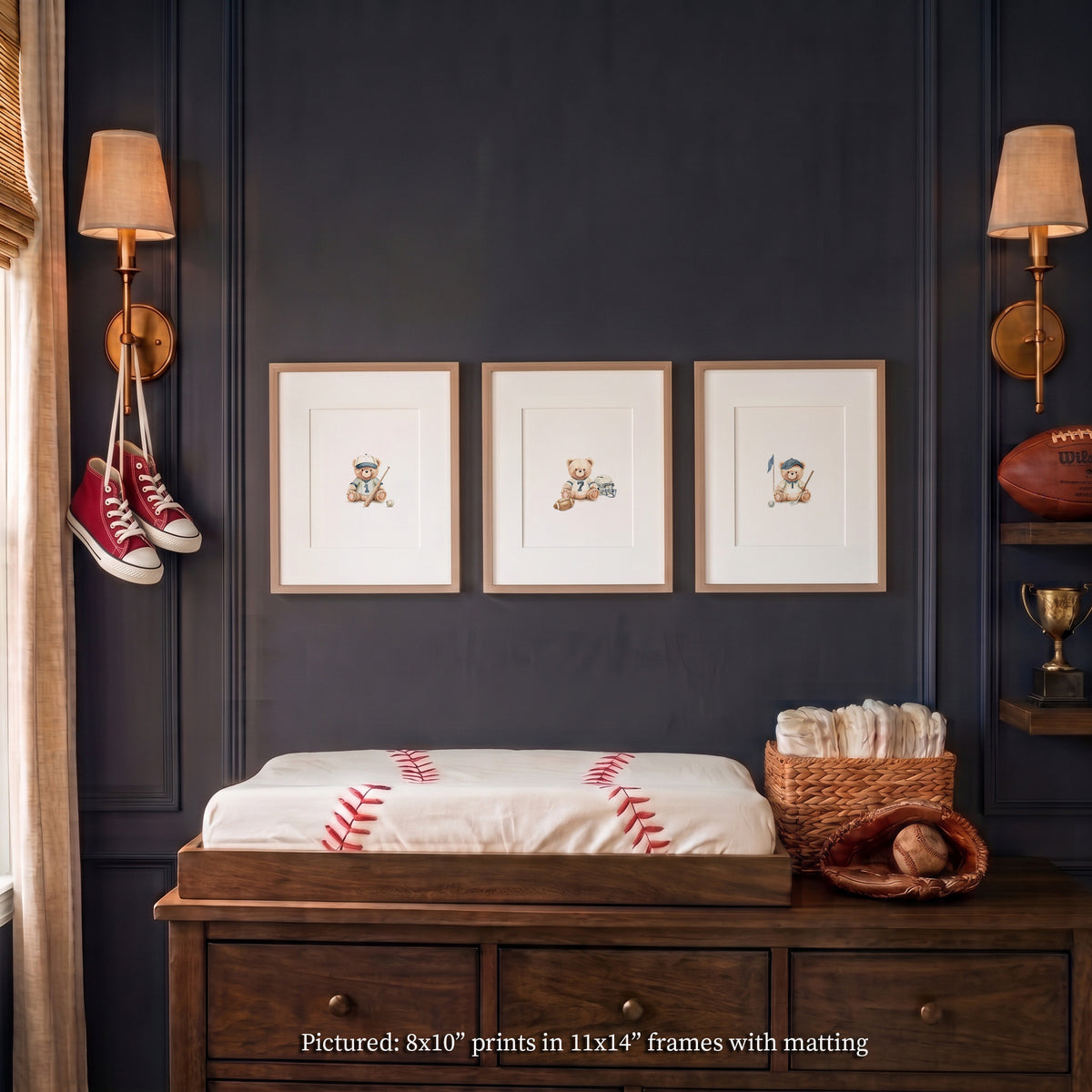 Set of 3 varsity teddy bear sports nursery wall art prints displayed in 11x14 matted wood frames above a changing table in a vintage navy boy's nursery. Sports featured are baseball, football and golf.