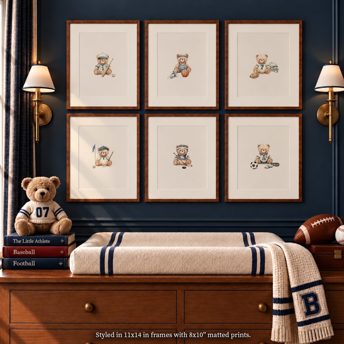 Vintage varsity nursery mockup featuring a 2x3 gallery wall of six watercolor sports teddy bear art prints (baseball, basketball, football, golf, soccer, tennis) in wood frames above a changing table with classic athletic accents.