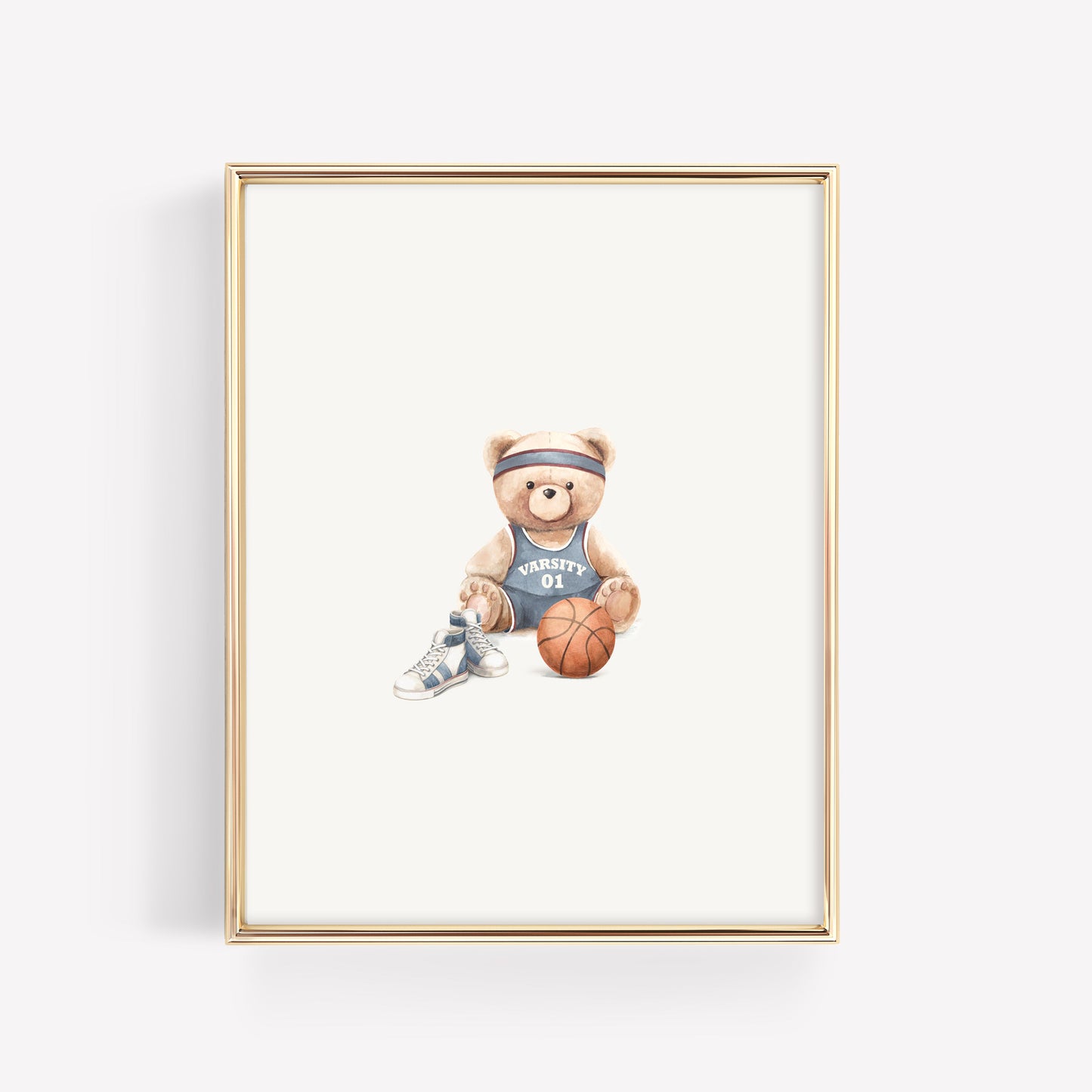 A framed art print featuring a watercolor illustration of a teddy bear wearing a basketball jersey, headband, sneakers, and holding a basketball, set in a thin gold frame against a white background.