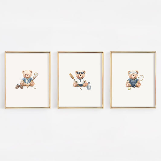 Three framed watercolor prints of teddy bears playing sports, displayed side-by-side on a white wall. The left bear plays lacrosse, the middle bear rows crew and the right bear plays tennis.