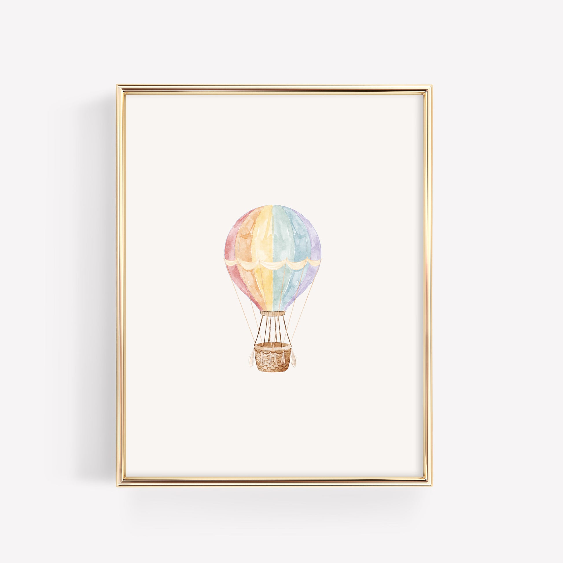 Single whimsical watercolor hot air balloon print in vibrant rainbow colors with fringe detail, part of a coordinated 3-piece nursery wall art set. Up up and away!