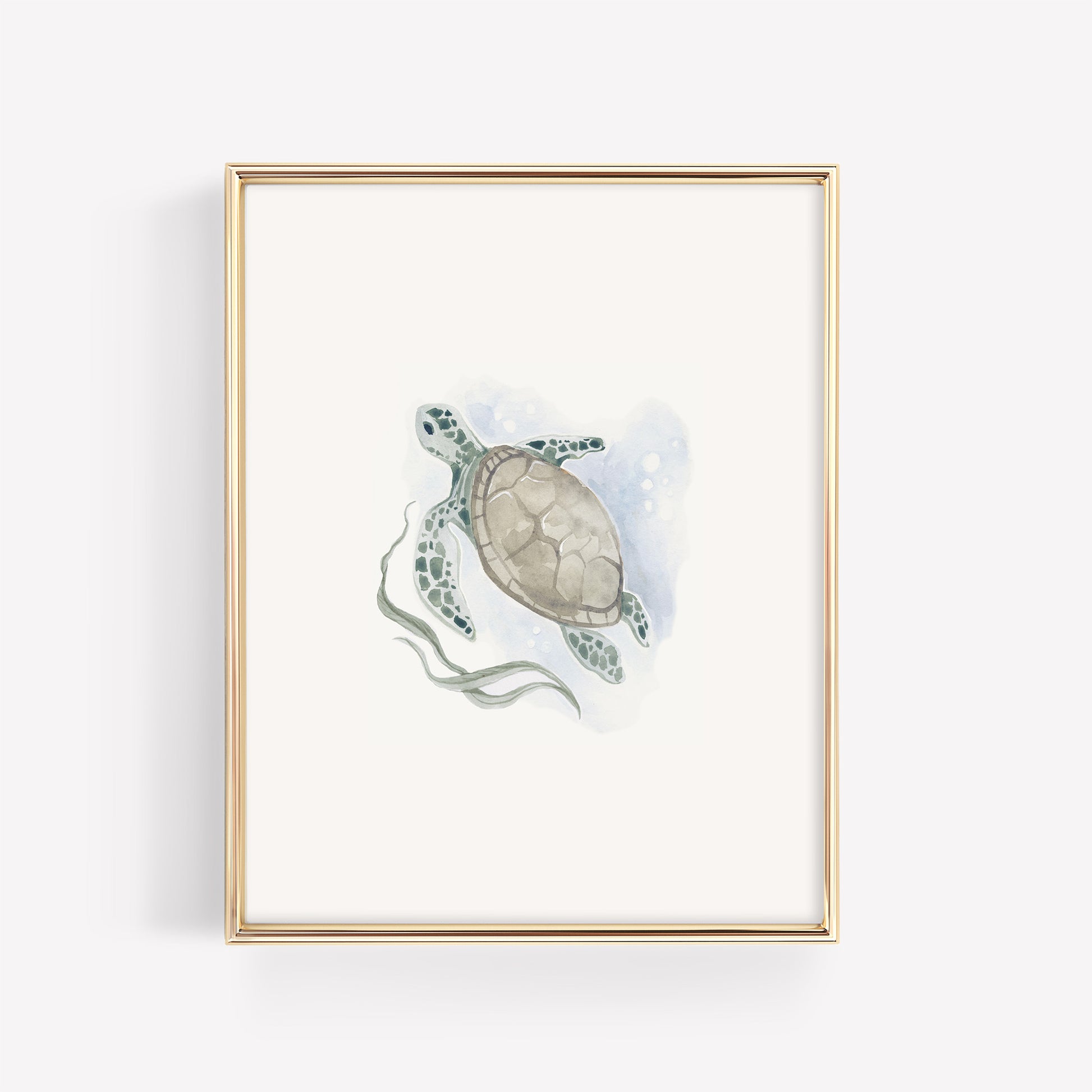 A soft teal and green watercolor sea turtle illustration in a minimalist gold frame, styled as ocean-themed wall art for a baby nursery.