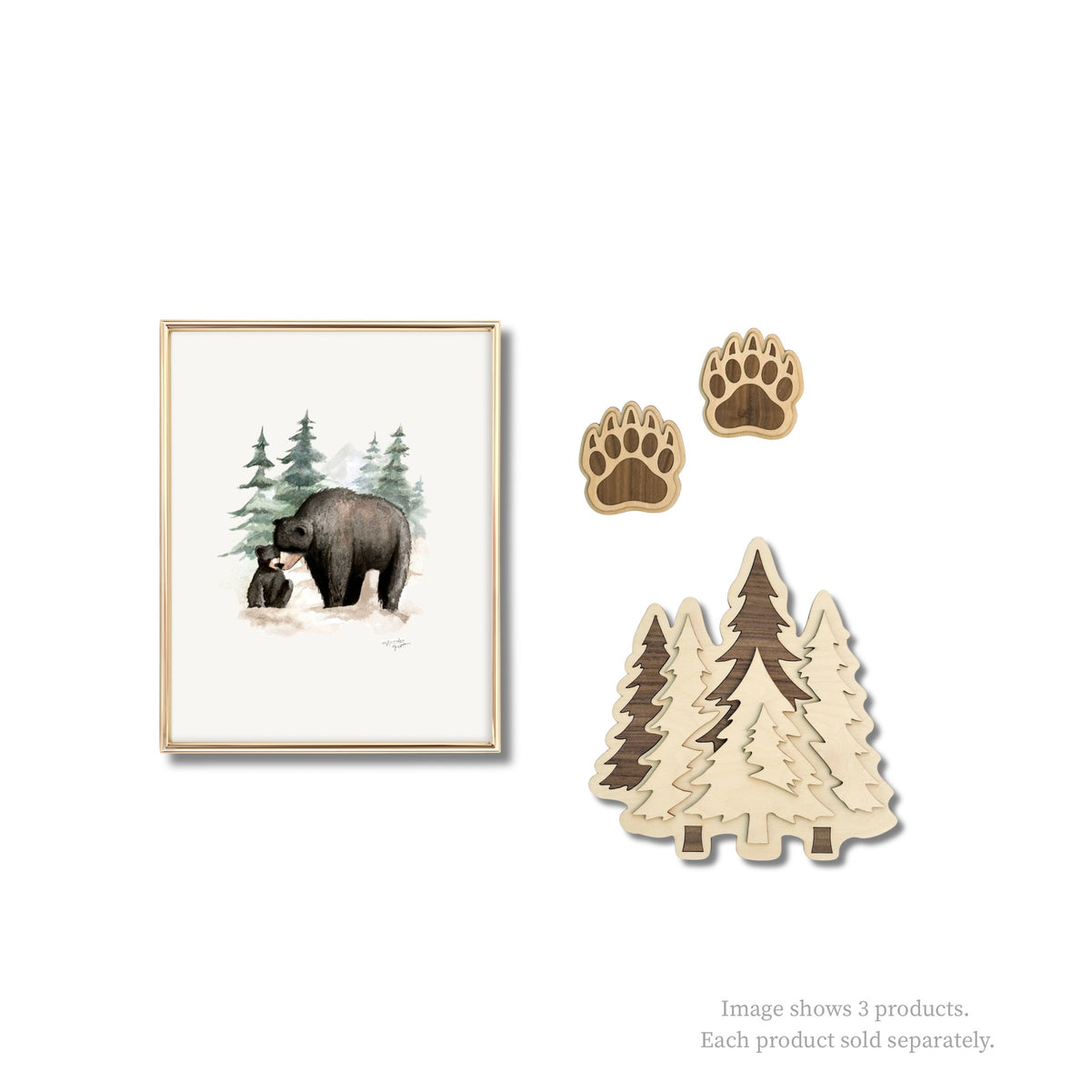 Framed artwork of a bear and trees, two wooden paw prints, and two wooden tree shapes on a white background.